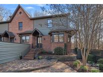 Charming brick and siding home featuring a beautiful front entry and landscaped yard at 7417 Newmans Ln, Charlotte, NC 28270