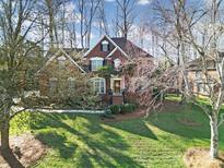 Charming two-story brick home with a well-manicured lawn and mature trees at 907 Thorn Ridge Ln, Lake Wylie, SC 29710