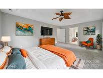 Bright bedroom featuring a ceiling fan and an orange accent chair for a cozy place to unwind at 907 Thorn Ridge Ln, Lake Wylie, SC 29710