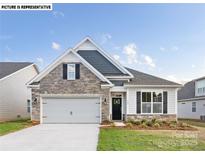 Charming home featuring a stone facade, gray shingle accents, and a two-car garage, showcasing great curb appeal at 109 Noah Ln, Troutman, NC 28166