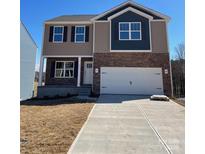 Inviting two-story home featuring stone accents, attached two-car garage, and a well-manicured lawn at 111 Rustling Waters Dr, Mooresville, NC 28117