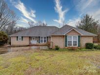 Charming brick home with green shutters, manicured landscaping and inviting front entrance at 112 Jeremy Dr, Kings Mountain, NC 28086