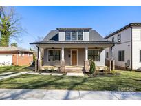 Charming home featuring a cozy front porch and well-manicured lawn at 1824 Haines St, Charlotte, NC 28216