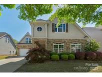 Charming two-story home featuring stone accents and a well-maintained front yard at 3009 Scottcrest Way, Waxhaw, NC 28173