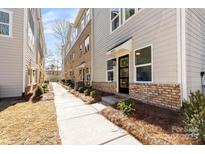 Beautiful townhome with a covered entryway and professionally landscaped front yard at 3820 Odom Ave, Charlotte, NC 28216