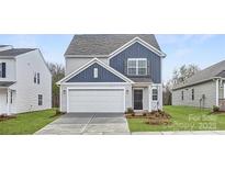 Charming two-story home with blue and gray siding, a two-car garage, and a well-manicured lawn at 5324 Small St, Catawba, NC 28609