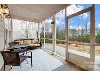 Relax on the screened porch with seating and enjoy the view of the outdoors at 6858 Hunts Mesa Dr, Fort Mill, SC 29707
