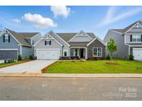 Charming single-Gathering home with a well-manicured lawn, stone accents, and an attached two-car garage at 8716 Acadia Pkwy # 596, Sherrills Ford, NC 28673