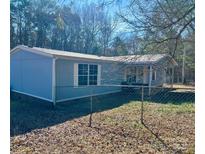 Charming single-story home featuring a light blue exterior, white trim, and a fenced yard at 13080 Philadelphia Church Rd, Oakboro, NC 28129