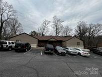 A well-maintained condo building is shown with ample parking spaces available for residents and guests at 1420 11Th Street Nw Dr # 25, Hickory, NC 28601