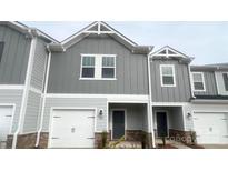 Charming two-story townhome featuring a one-car garage and modern gray siding at 1762 Braemar Village Dr, Monroe, NC 28110