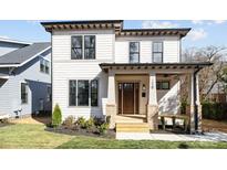 Charming two-story home with a covered front porch, landscaped yard, and modern design elements at 1828 Haines St, Charlotte, NC 28216