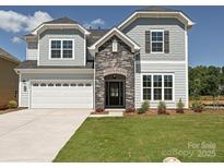 Charming two-story home features a stone entryway, attached two-car garage, and manicured lawn at 2204 Camber Dr # Cwo0076, Gastonia, NC 28054