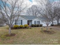 Charming single-Gathering home features manicured landscaping, a well-kept lawn, and a classic facade with a red front door at 3248 St Vincent Dr, Claremont, NC 28610
