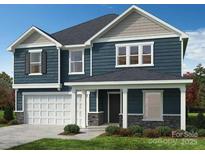 Beautiful two-story home features a front porch, two-car garage, dark blue siding, and stone accents at 334 Knotty Wood Dr # 68, Monroe, NC 28110