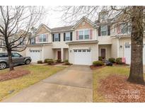 Inviting two-story townhome featuring a one-car garage, tidy landscaping, and neutral siding at 446 Clouds Way Way, Rock Hill, SC 29732