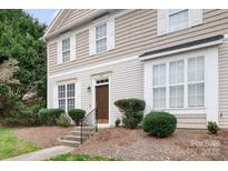 Charming home featuring a neat lawn, trimmed shrubs, and a classic brown front door with white trim at 542 Goldstaff Ln, Charlotte, NC 28273