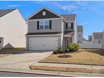 Charming two-story home with gray siding, an attached garage, and a well-maintained front yard at 709 Daniel Ln, Richburg, SC 29729