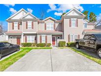 Charming townhome featuring a well-maintained lawn and private driveway at 8263 Carob Tree Ln, Charlotte, NC 28215