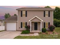 Charming two-story home with neutral siding, black shutters, and a well-manicured front yard at 8309 Knapp Ct, Locust, NC 28097