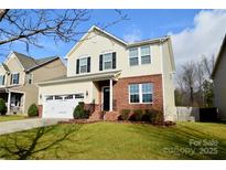 Charming two-story home with brick and siding, a well-manicured lawn, and an attached two-car garage at 856 Wingthorn Rose Dr, Gastonia, NC 28056