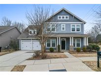 Charming two-story home with a two-car garage, inviting porch, and manicured landscaping at 11604 Bradford Park Dr, Davidson, NC 28036