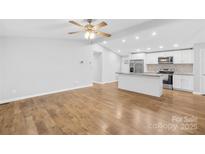 Bright, open living space flows into a modern kitchen with stainless steel appliances and light wood floors at 133 Hallmark Estates Dr, Statesville, NC 28625