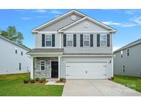Charming two-story home featuring neutral siding, black shutters, and a well-manicured lawn at 213 Lake George Dr, Shelby, NC 28152