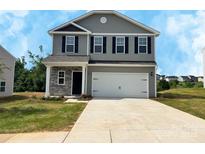 Charming two-story home featuring gray siding, black shutters, and a spacious two-car garage at 213 Lake George Dr, Shelby, NC 28152