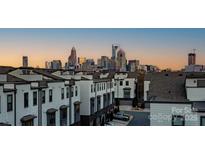 Modern townhomes showcase stunning city skyline views in the background at 2306 Elizabeth Mill Pl, Charlotte, NC 28208