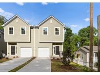 Charming new construction townhomes featuring a neutral color palette, one car garage, and well manicured yard at 2825 New Pineola Rd # 7A, Charlotte, NC 28208