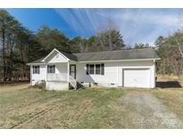 Charming one-story home with white siding, attached garage, and front porch in a wooded setting at 4175 Barnell Ln, Maiden, NC 28650