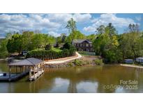 Stunning lakefront property with a private dock and beautifully landscaped yard, offering serene waterfront living at 6233 Riviera Run Estates Dr, Hickory, NC 28601