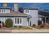 Charming townhome featuring stone chimney, tidy landscaping, gray siding and a welcoming front entrance at 1027 21St Ne Ave, Hickory, NC 28601