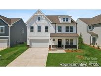 Charming two-story home with a modern white facade, attached two-car garage, and neatly manicured front lawn at 1150 Zettie Ave # 19, Kannapolis, NC 28083