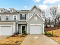 Charming townhome with light gray siding, black shutters, and an attached one-car garage at 1365 Eagle Claw Dr, Kannapolis, NC 28083