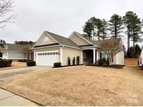 Charming single-story home with a two-car garage and well-maintained lawn at 2023 Moultrie Ct, Fort Mill, SC 29707