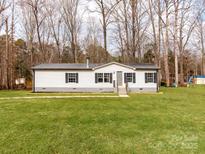 Charming single-story home with well-maintained lawn and classic white siding at 236 Sailwinds Rd, Mooresville, NC 28115