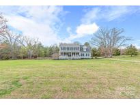 Charming two-story home with a large front yard, covered porch, and classic colonial architecture at 3929 Wexford Ln, Denver, NC 28037