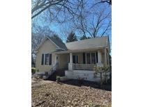 Charming yellow house with a inviting front porch and dark shutters at 201 N Crawford St, Monroe, NC 28112