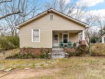 Charming bungalow featuring vinyl siding and a welcoming front porch, ready for personalization at 310 Center St, Kannapolis, NC 28083