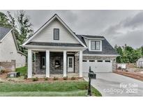 Charming home featuring a modern design with a covered porch and well-maintained front lawn at 32 Shanklin S Ln # 32, Denver, NC 28037