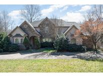 Charming stone and stucco home featuring an inviting front lawn and mature landscaping at 4724 1St Ne St, Hickory, NC 28601