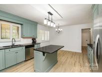 Bright kitchen with granite countertops, island, stainless steel appliances, and lots of natural light at 7407 Forney Hill Rd, Denver, NC 28037