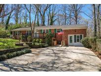 Charming single-story brick home with a lush front yard, a cozy porch, and driveway parking at 8101 Kerrybrook Cir, Charlotte, NC 28214