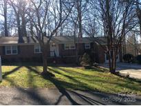 Charming brick home with a well-maintained lawn and mature trees at 8101 Kerrybrook Cir, Charlotte, NC 28214
