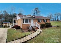 Beautiful brick house with a landscaped yard and a stone pathway at 114 Eller Rd, Gastonia, NC 28056