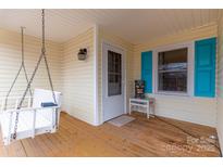 Inviting covered front porch featuring a charming porch swing and bright blue shutters at 115 Setter Ct, Statesville, NC 28625