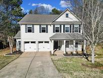 Inviting two-story home with a two-car garage, landscaped yard, and classic black shutters at 15603 Pine Glen Ct, Charlotte, NC 28273