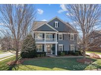Charming two-story home with a welcoming front porch and professionally landscaped front yard at 2200 Trading Ford Dr, Waxhaw, NC 28173